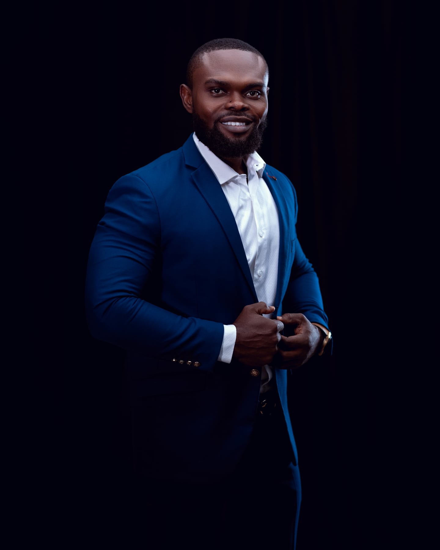 Chiwilzy smiling in a tailored blue suit